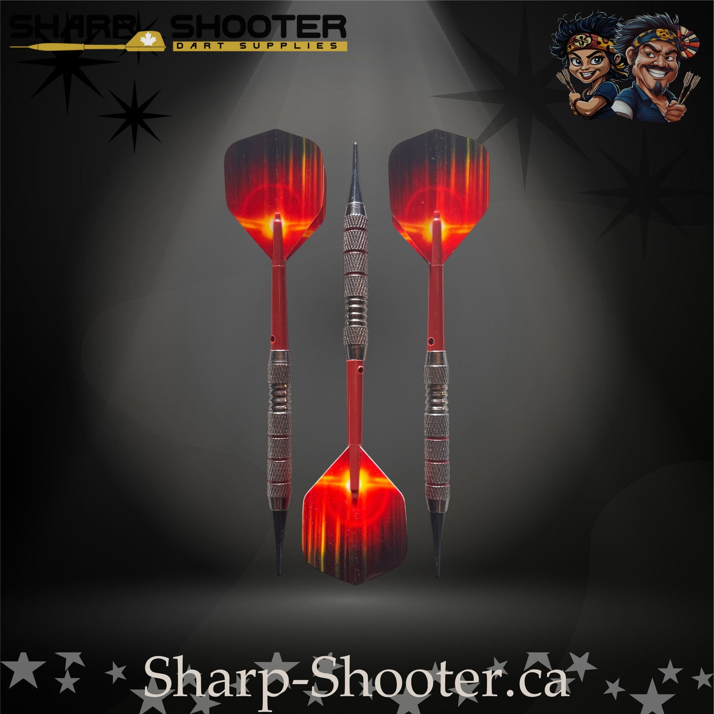 Sunset soft-tip dart set featuring red gradient flights, red shafts, silver ringed barrels, and black soft tips on a dark spotlight background.