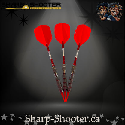 Cherry Bomb soft-tip dart set with red flights, red shafts, and a ringed metallic barrel on a dark spotlight background