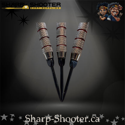 Cherry Bomb steel-tip dart set with bright red flights, red shafts, and a textured metallic barrel showcased on a dark star-pattern background.