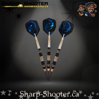 Essence steel-tip dart set featuring black textured barrels with gold rings and matching blue swirl flights, displayed on a dramatic spotlight backdrop