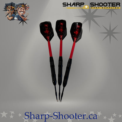 Red Baron steel dart set with straight black barrels, red sparkle flights, and plastic shafts on grey studio background