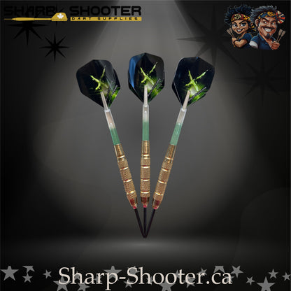 Sniper steel-tip dart set with gold knurled barrels, green-gradient shafts and green energy burst flights on a dark spotlight background.