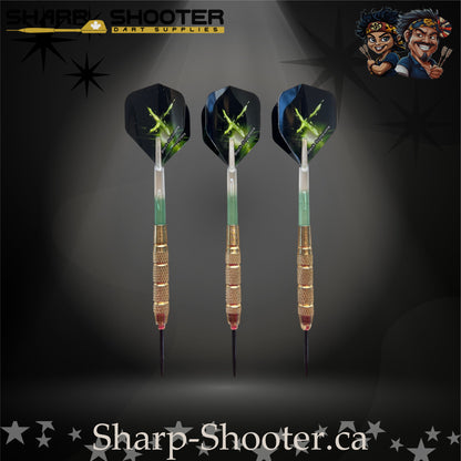 Sniper steel-tip dart set with gold knurled barrels, green-gradient shafts and green energy burst flights on a dark spotlight background.