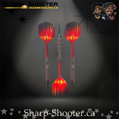 Sunset steel-tip dart set with red gradient flights, red shafts, and silver ringed barrels on a dark spotlight background.