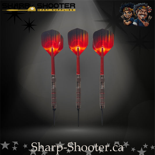 Sunset steel-tip dart set with red gradient flights, red shafts, and silver ringed barrels on a dark spotlight background.
